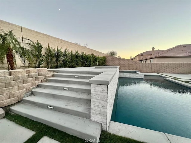 43118 Fiore St, Indio, CA 92203 - view of swimming pool featuring a fenced backyard and a pool with connected hot tub