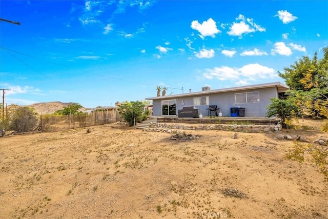 back of house with a patio and fence