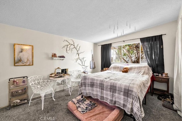 bedroom featuring a textured ceiling and carpet floors