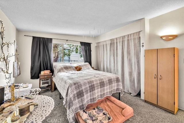 bedroom featuring light carpet and a textured ceiling