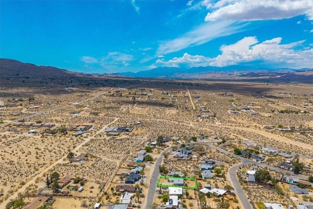 aerial view featuring a mountain view, a desert view, and a rural view