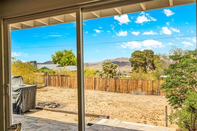 view of patio / terrace featuring a mountain view and fence