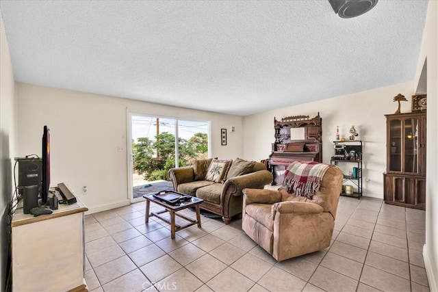 living room with a textured ceiling, baseboards, and light tile patterned floors