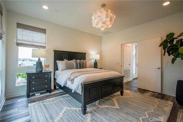 bedroom with visible vents, wood finished floors, baseboards, and recessed lighting