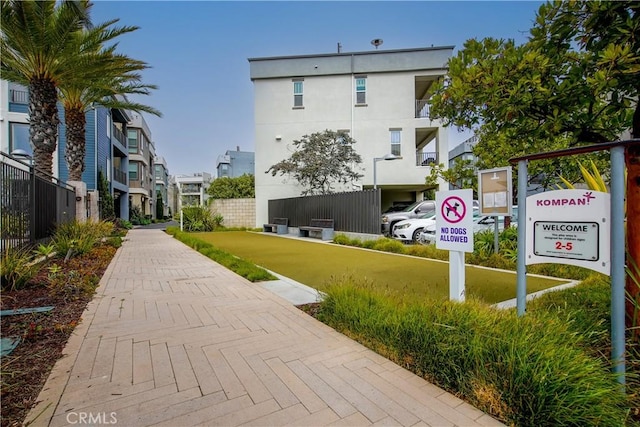 view of community featuring fence and a residential view