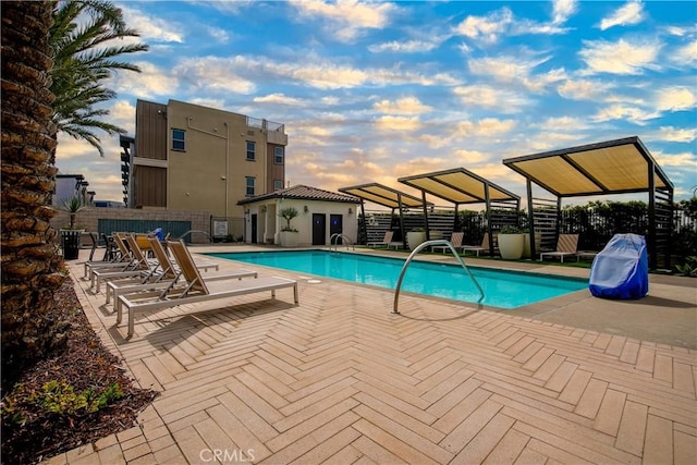 community pool featuring a patio area and fence
