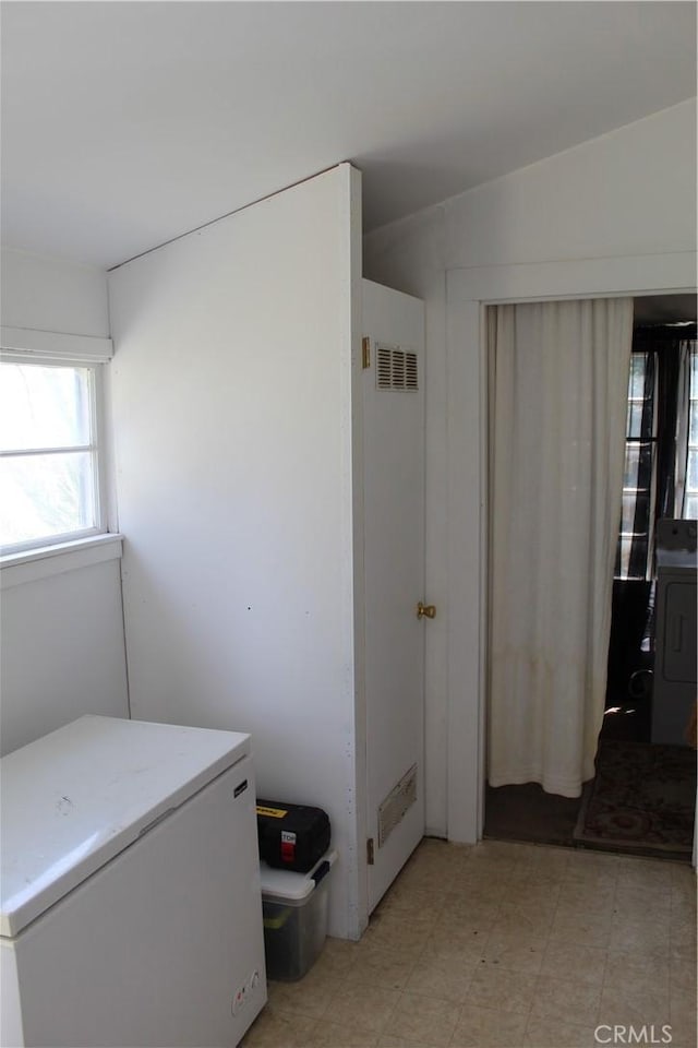 bathroom featuring washer / dryer, tile patterned floors, and visible vents