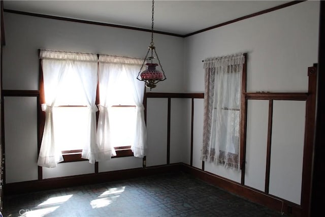 unfurnished dining area with crown molding and tile patterned floors