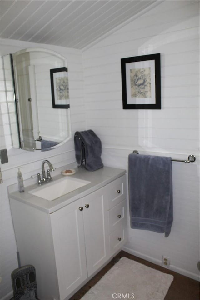 bathroom with vaulted ceiling and vanity