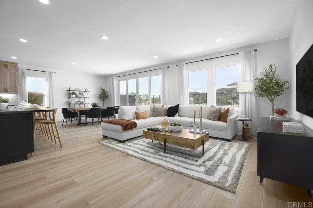 living area featuring light wood-style floors and recessed lighting