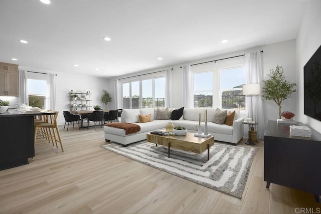 living area featuring light wood-style floors and recessed lighting