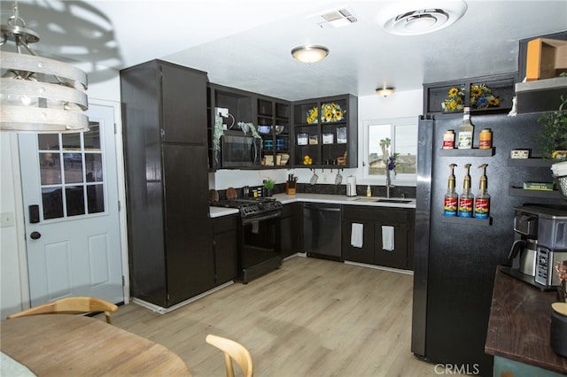 73881 Siesta Dr Unit 29, Palms, CA 92277 - bar featuring a sink, light wood-type flooring, black appliances, and visible vents