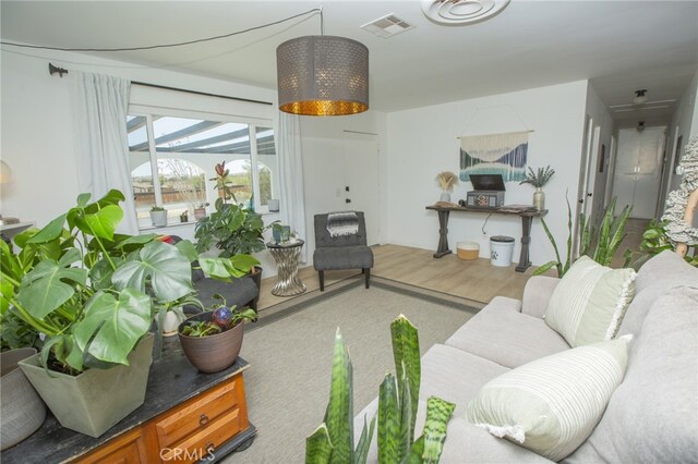 73881 Siesta Dr Unit 29, Palms, CA 92277 - living room featuring visible vents and wood finished floors
