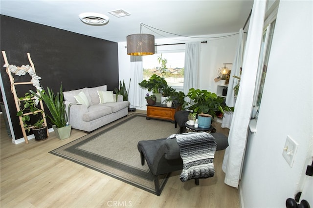 73881 Siesta Dr Unit 29, Palms, CA 92277 - living room featuring visible vents and wood finished floors
