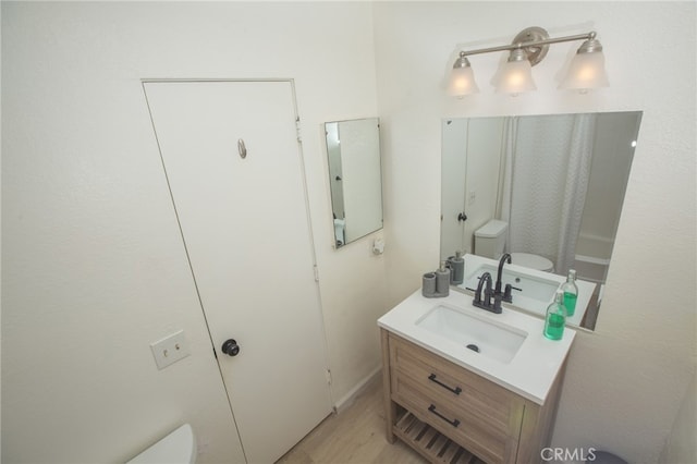 73881 Siesta Dr Unit 29, Palms, CA 92277 - full bathroom with toilet, vanity, a shower with shower curtain, and wood finished floors