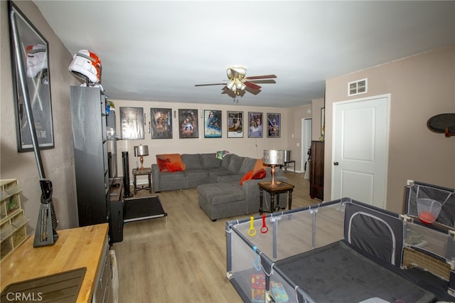 73881 Siesta Dr Unit 29, Palms, CA 92277 - living area featuring light wood finished floors, ceiling fan, and visible vents