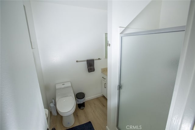 73881 Siesta Dr Unit 29, Palms, CA 92277 - bathroom with toilet, wood finished floors, vanity, a shower stall, and baseboards
