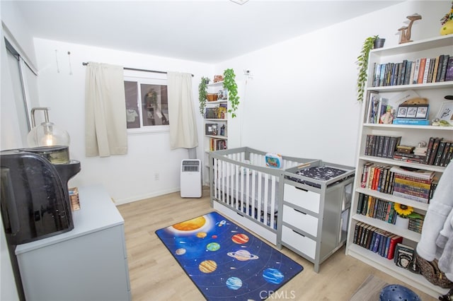 73881 Siesta Dr Unit 29, Palms, CA 92277 - bedroom featuring a nursery area, baseboards, and wood finished floors