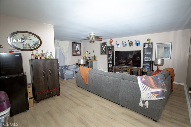 73881 Siesta Dr Unit 29, Palms, CA 92277 - living room featuring light wood-style flooring and ceiling fan