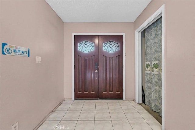 entrance foyer featuring light tile patterned floors