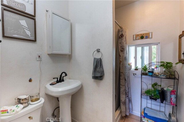 113 E White St, Barstow, CA 92311 - bathroom with toilet and a shower with shower curtain