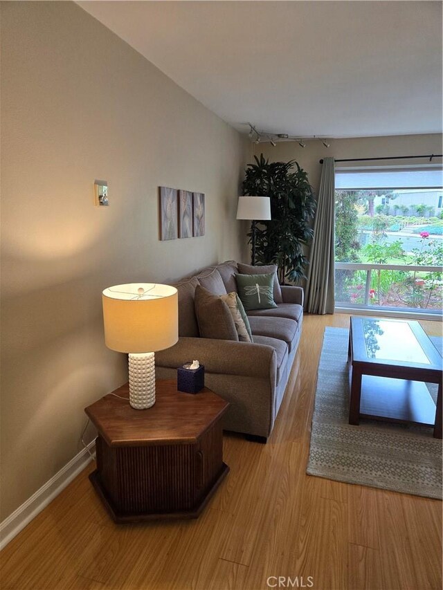 185 Avenida Majorca Unit A, Laguna Woods, CA 92637 - living room with light wood-type flooring and baseboards