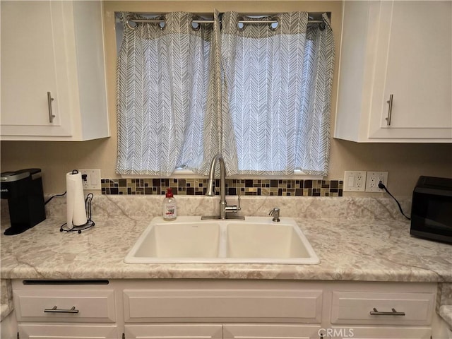 185 Avenida Majorca Unit A, Laguna Woods, CA 92637 - kitchen with a sink, white cabinetry, and light countertops