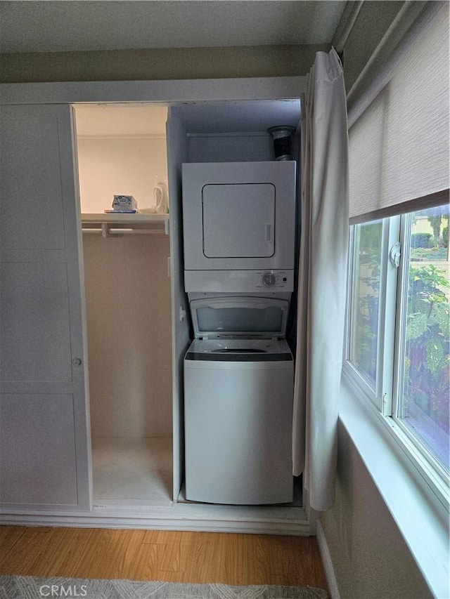 185 Avenida Majorca Unit A, Laguna Woods, CA 92637 - washroom with stacked washer / dryer and wood finished floors