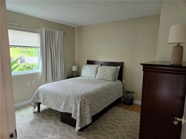 185 Avenida Majorca Unit A, Laguna Woods, CA 92637 - bedroom featuring baseboards and wood finished floors