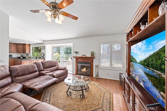2757 Cape Dr, Corona, CA 92882 - living room with a glass covered fireplace, light wood-style flooring, a ceiling fan, and recessed lighting
