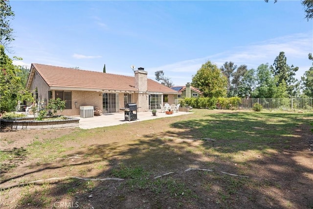 2757 Cape Dr, Corona, CA 92882 - rear view of house featuring a patio area, a chimney, a fenced backyard, stucco siding, and a tiled roof
