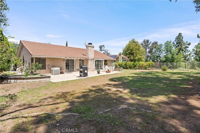 2757 Cape Dr, Corona, CA 92882 - rear view of property featuring a patio, a fenced backyard, a chimney, stucco siding, and a tiled roof