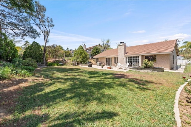2757 Cape Dr, Corona, CA 92882 - rear view of house with a patio area, a chimney, a yard, and stucco siding