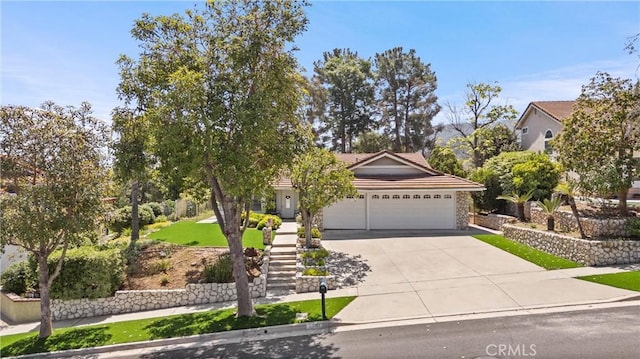 2757 Cape Dr, Corona, CA 92882 - view of property hidden behind natural elements featuring driveway, a garage, stone siding, a tile roof, and stairs