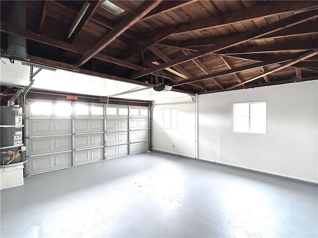garage with water heater, a garage door opener, and baseboards
