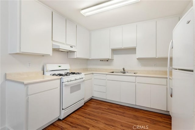 kitchen featuring under cabinet range hood, white cabinets, a sink, and white appliances