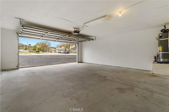 garage with secured water heater and a garage door opener