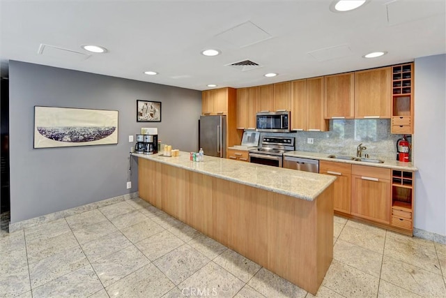800 W 1st St Unit 710, Los Angeles, CA 90012 - kitchen featuring stainless steel appliances, a sink, a peninsula, baseboards, and light stone countertops