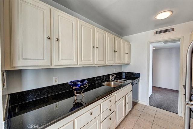 800 W 1st St Unit 710, Los Angeles, CA 90012 - kitchen featuring a sink, dishwashing machine, light carpet, light tile patterned floors, and dark stone countertops