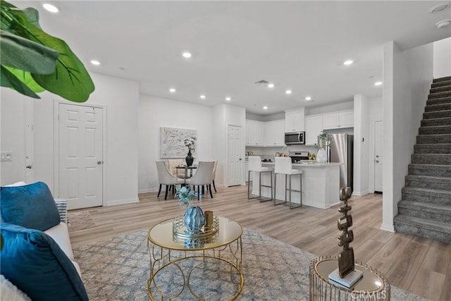 3981 E Huntington St, Ontario, CA 91761 - living area with recessed lighting, light wood-type flooring, and stairs