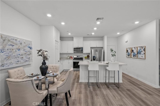 3981 E Huntington St, Ontario, CA 91761 - dining room with baseboards, recessed lighting, visible vents, and light wood-type flooring