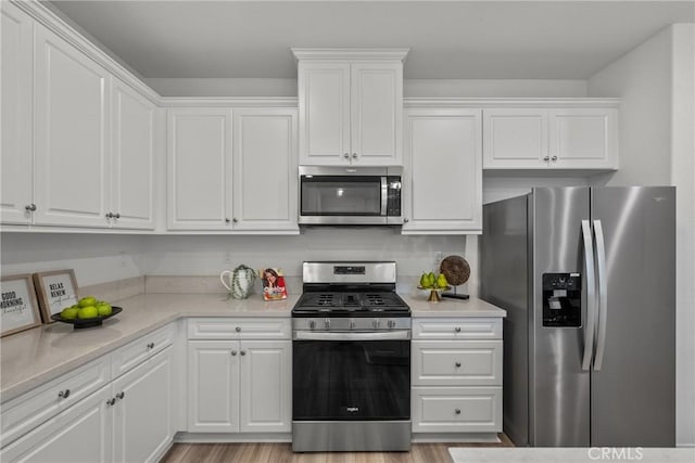 3981 E Huntington St, Ontario, CA 91761 - kitchen with light wood finished floors, light countertops, stainless steel appliances, and white cabinets