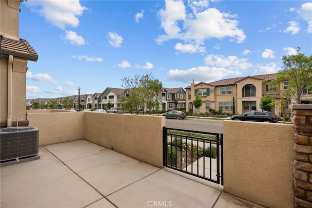 3981 E Huntington St, Ontario, CA 91761 - view of patio featuring central AC unit and a residential view