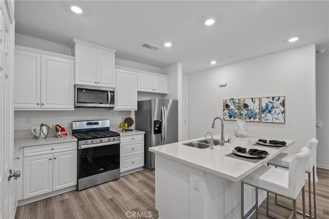 3981 E Huntington St, Ontario, CA 91761 - kitchen featuring light wood-style floors, appliances with stainless steel finishes, visible vents, and a sink