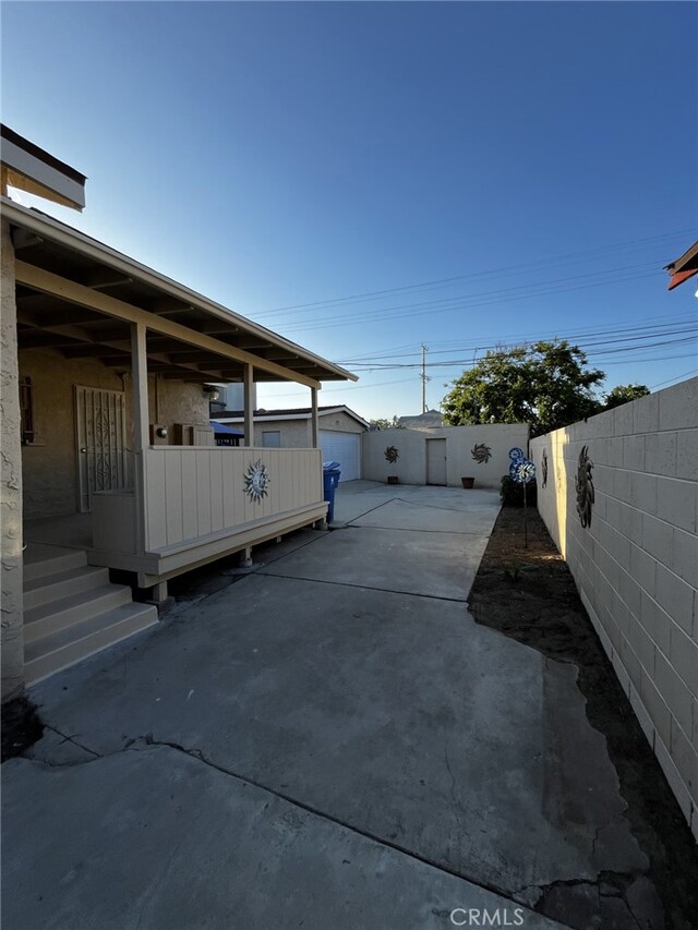 1449 W 45th St, Los Angeles, CA 90062 - view of patio / terrace featuring fence, an outdoor structure, and concrete driveway
