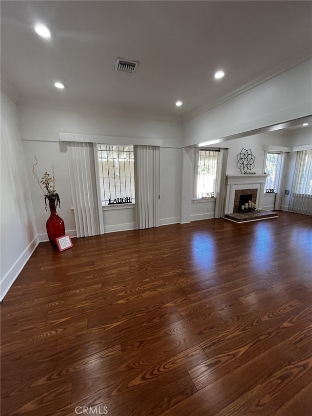 1449 W 45th St, Los Angeles, CA 90062 - unfurnished living room with wood finished floors, a fireplace with raised hearth, recessed lighting, baseboards, and crown molding