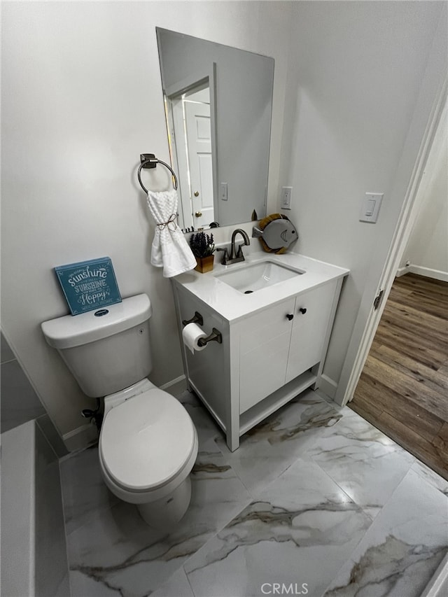 1449 W 45th St, Los Angeles, CA 90062 - bathroom with marble finish floors, toilet, vanity, and baseboards