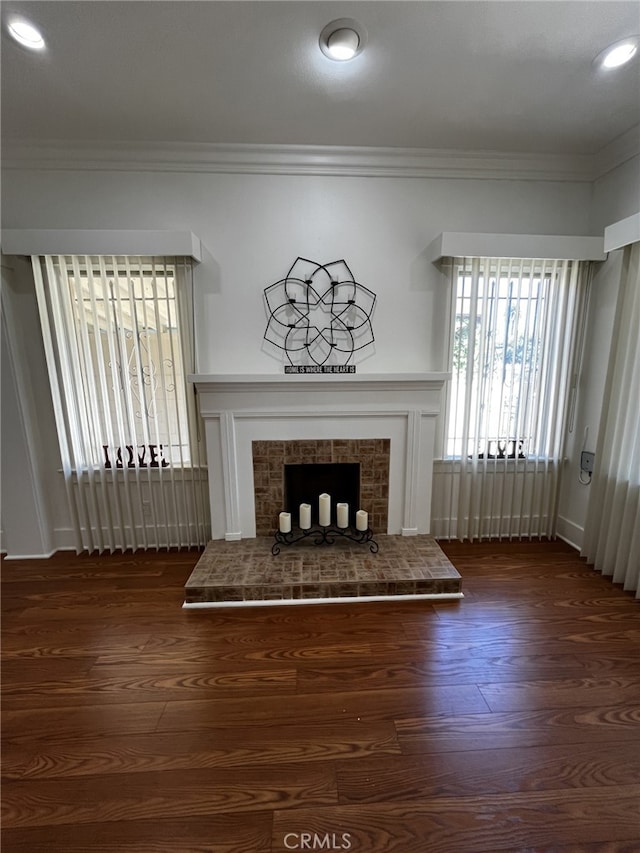 1449 W 45th St, Los Angeles, CA 90062 - unfurnished living room with a fireplace, crown molding, dark wood-style floors, and recessed lighting