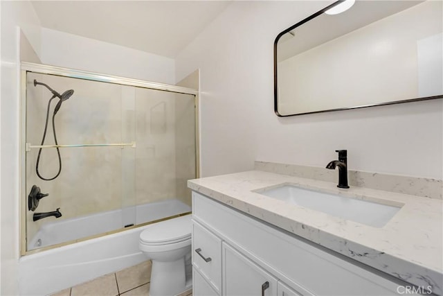 bathroom with vanity, toilet, shower / bath combination with glass door, and tile patterned floors