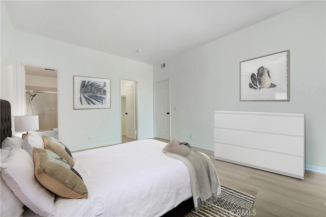 bedroom with baseboards and light wood-style flooring